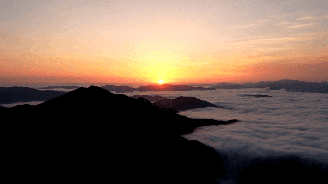Sunrise over a mountain with clouds