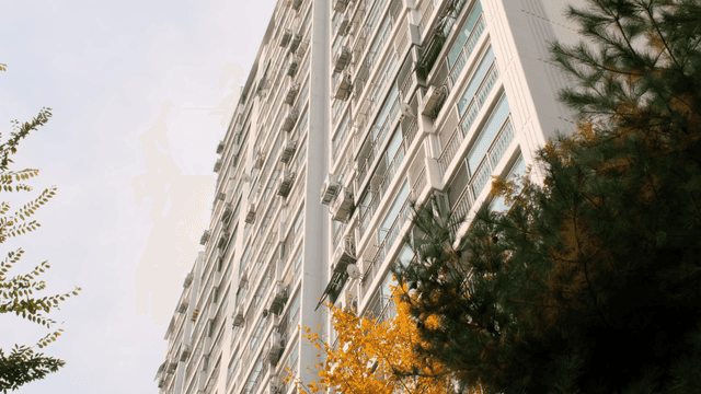 Tall apartment building with trees