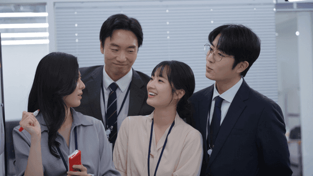 Colleagues discussing ideas at a board