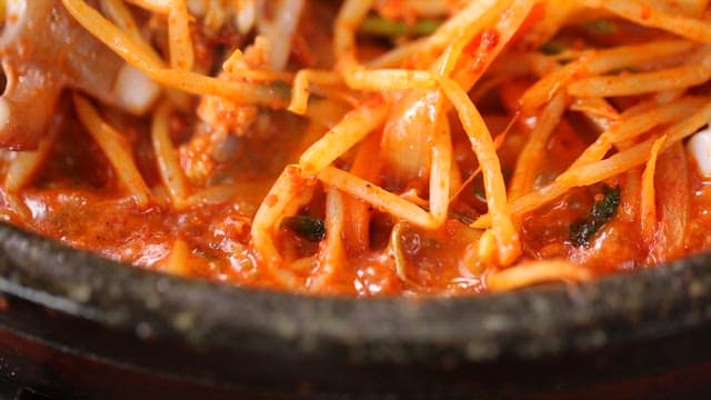 Spicy seasoned braised octopus  with bean sprouts being boiled