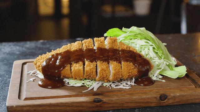 Crispy tonkatsu with cabbage on a board