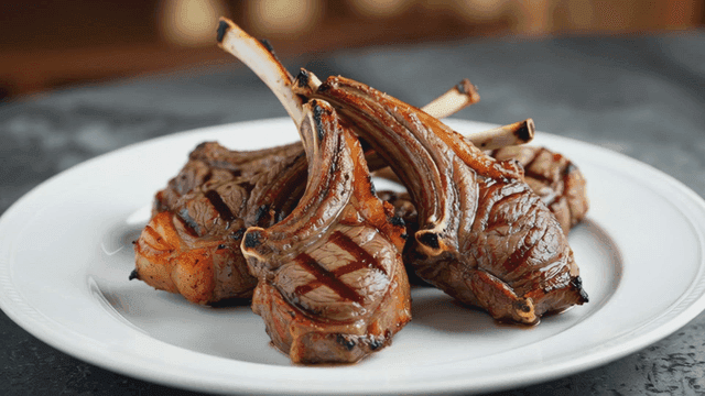 Grilled lamb chops on a white plate