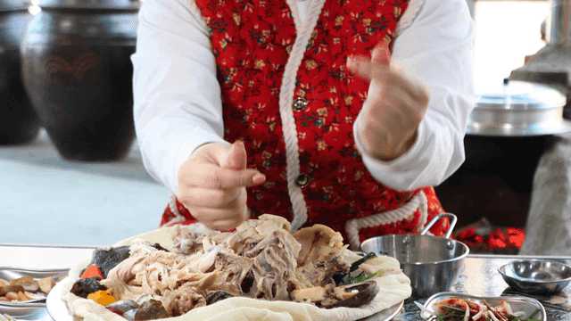 Person sending finger heart to traditional braised native chicken.