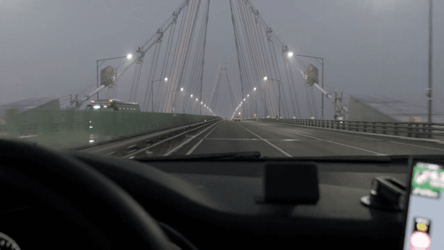 Driving on a bridge during foggy evening