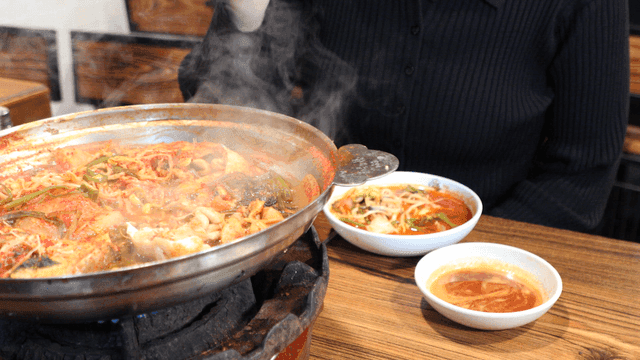 People eating spicy cod soup