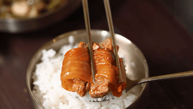 Kimchi and pork on rice in a bowl
