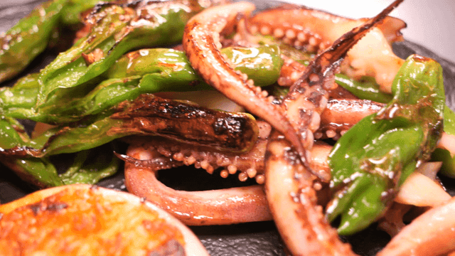 Grilled squid sundae legs and chili peppers on plate