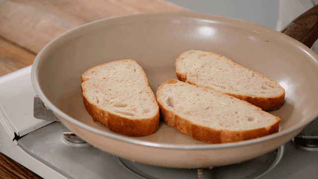 Slices of bread being toasted in a pan