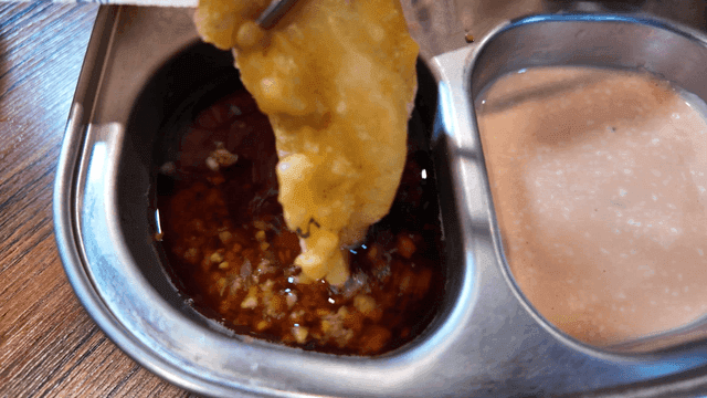 Crispy cod fritters dipped in sauce