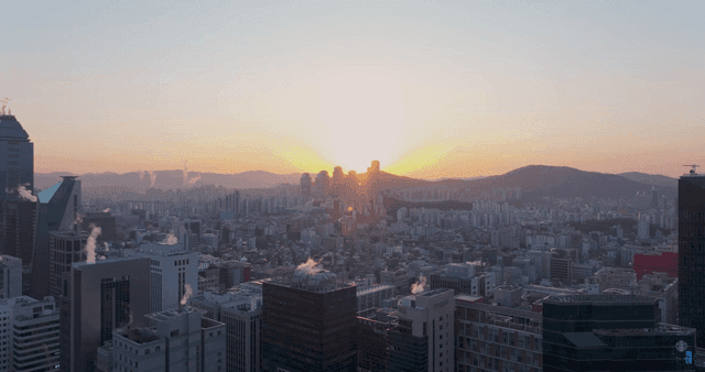 Sunrise over a bustling city skyline