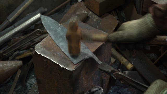 Craftsman forging a metal blade