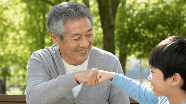 Grandfather and grandson sharing a fist bump