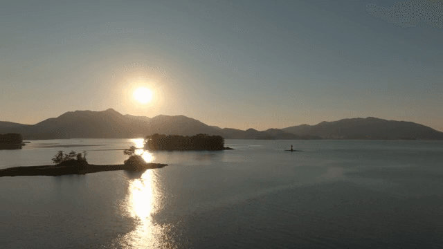 Sunset over a tranquil sea with islands