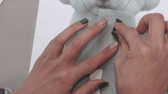 Hands doing puppy doll crafts