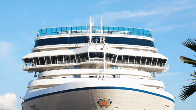 Large cruise ship docked under clear sky
