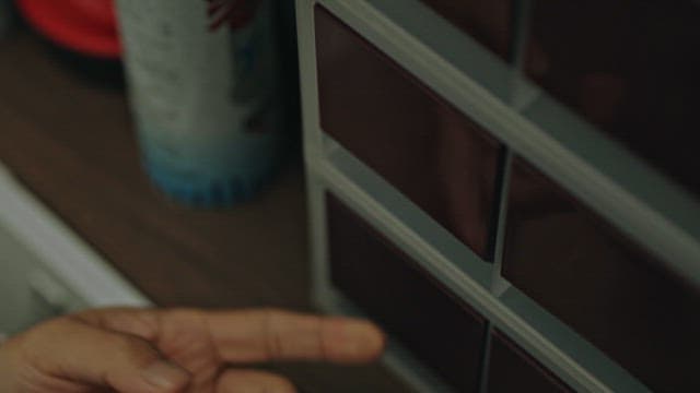 서랍에서 열쇠를 꺼내는 사람의 손 클로즈업