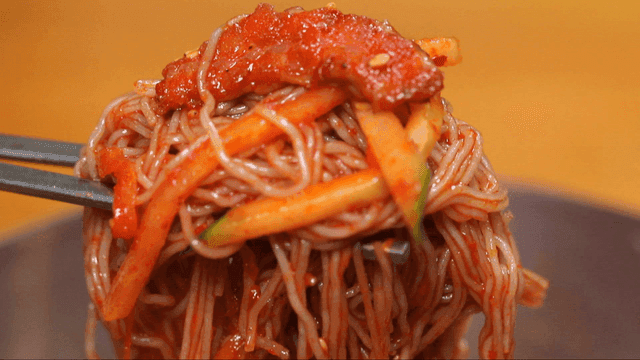 Bite of spicy buckwheat noodles with vegetables