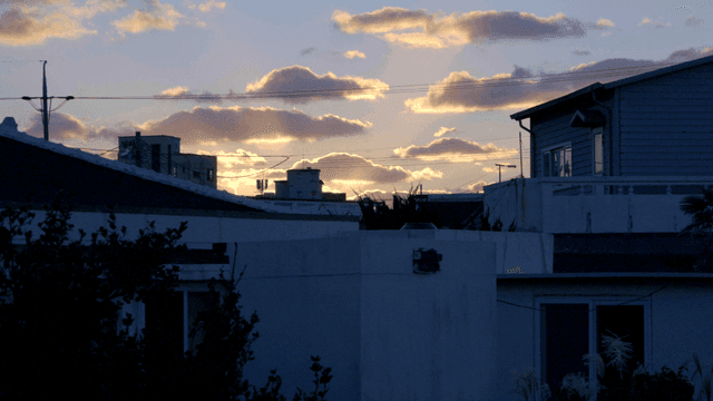 Sunset over rooftops of residential area