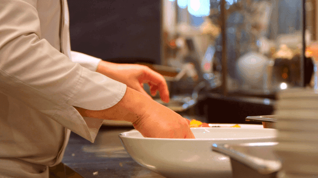 Chef preparing a dish with precision