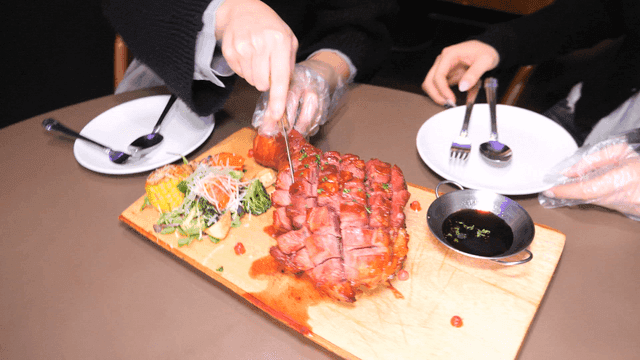 Sliced ​​roast turkey legs with salad