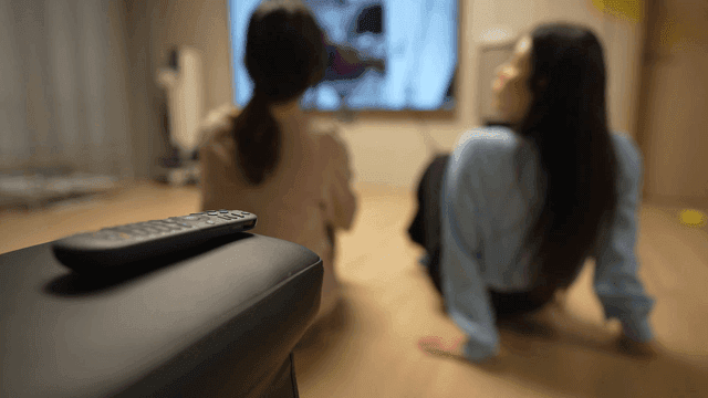 Two women watching TV in a cozy room
