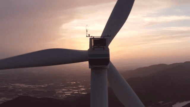 Wind turbines in a mountainous area with the setting sun