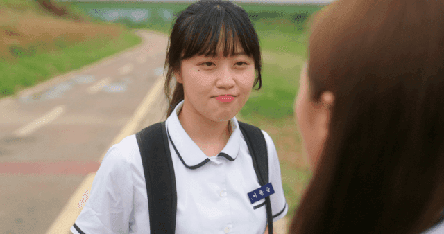 Two students having a conversation on a path
