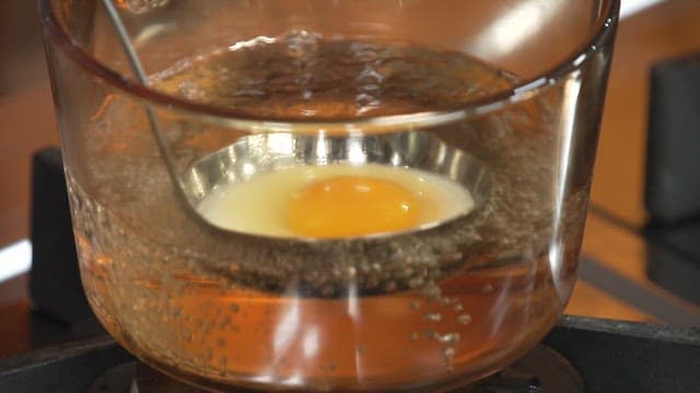 Cooking a Poached Egg in a Pot with Boiling Water