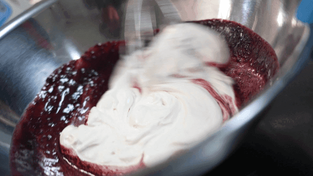 Whisk to mix cream and berry sauce in bowl
