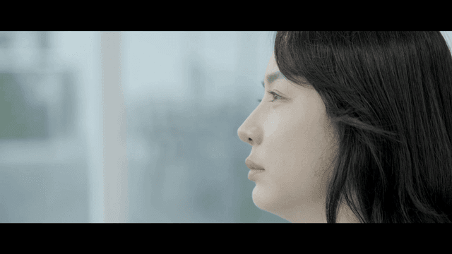 Woman gazing out window lost in thought