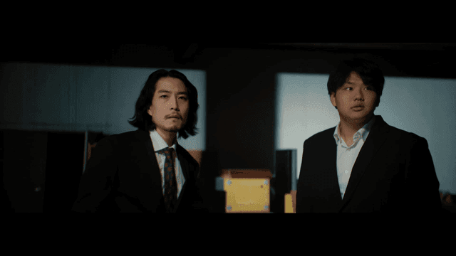 Two man in suits angry in a dark warehouse