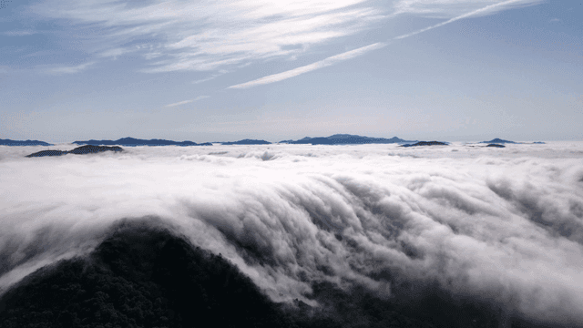 Clouds cascading over a mountain range