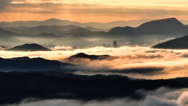 Clouds colored by the sunset running along the mountain range