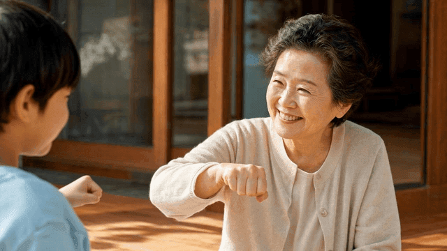 Grandmother and child sharing a fist bump