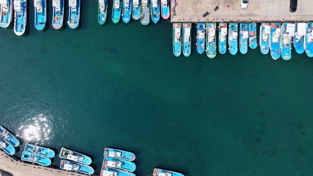 Coastal village with fishing boats and breakwaters