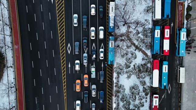 Snowy Urban Road with Running Vehicles