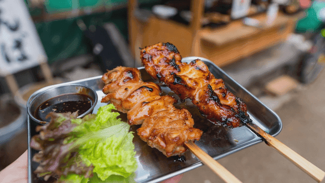 Grilled skewers served with sauce and lettuce