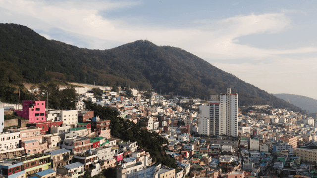 Colorful hillside village with mountain backdrop