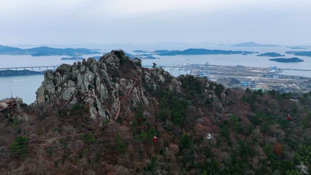 Mountain with cable cars and sea view