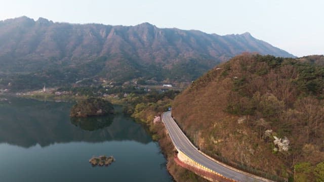 Winding road by a serene mountain lake