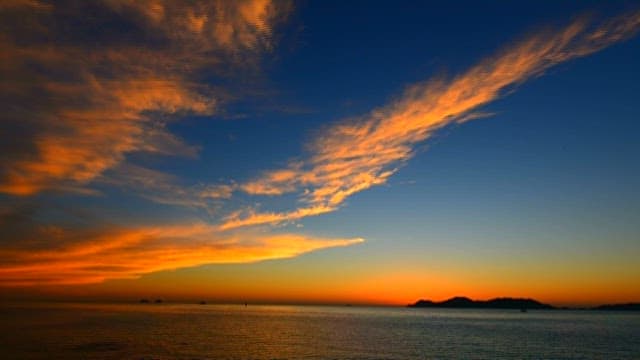 Serene and Red Sunset Over Calm Seaside