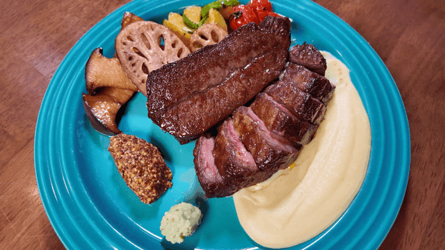 Steak dish with vegetable garnish