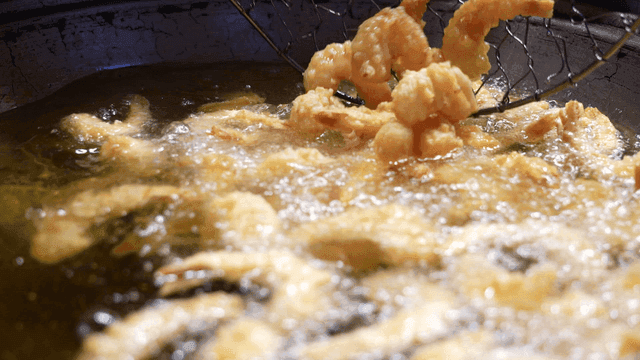 Shrimp tempura frying in hot oil