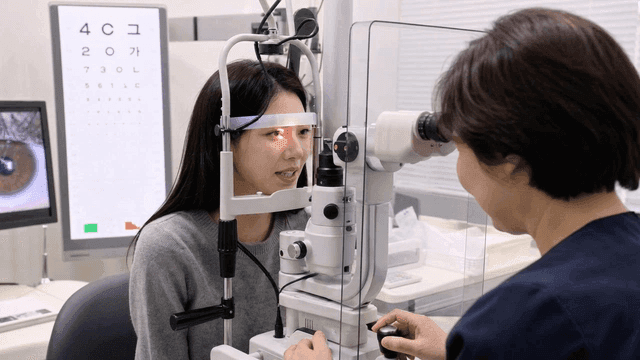 Young woman receiving eye exam at clinic