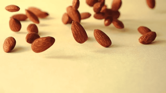 Almonds falling on yellow ground