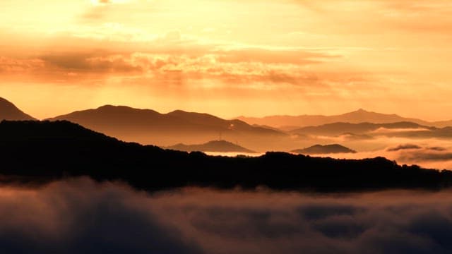 Sunrise over misty mountains