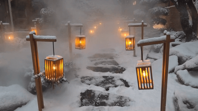 Snowy path with lanterns in a garden
