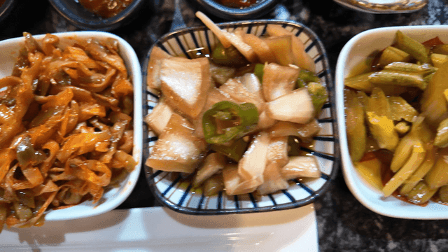 Variety of restaurant side dishes served in small bowls