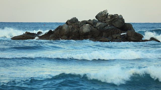 Sea Waves Crashing Against Large Rocks