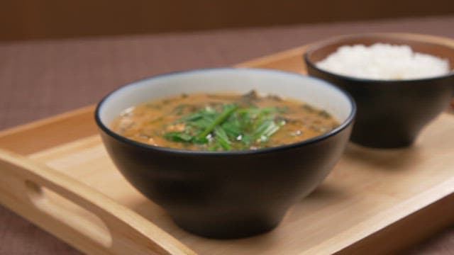 Bowl of hot chueotang and rice on a wooden tray